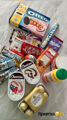 an assortment of snacks and condiments laid out on a marble counter top,