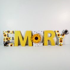 the word memory spelled with sunflowers and bees