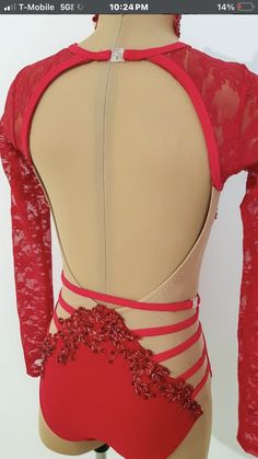 the back of a woman's red leotard with sheer lace and beading