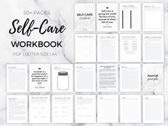 the self - care workbook is surrounded by papers and notebooks on a marble surface