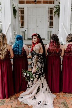 the bridesmaids are dressed in red and black gowns