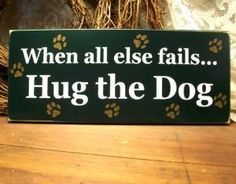 a sign that says when all else falls hug the dog with paw prints on it