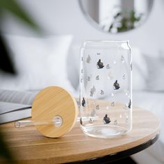 a table with a glass jar and wooden paddle on it, next to a mirror