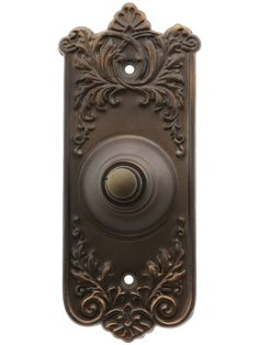 an antique style door handle with a decorative design on the front and back panel, in bronze