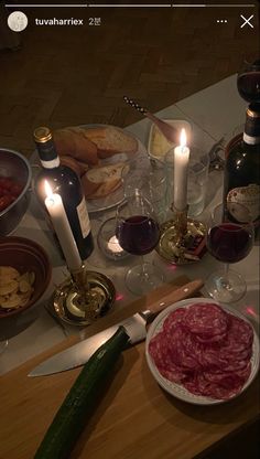 a table topped with lots of food and wine