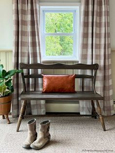 a wooden bench sitting in front of a window