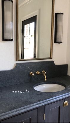 a bathroom sink sitting under a large mirror