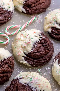 chocolate cookies with white frosting and candy canes