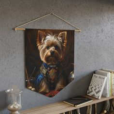 a dog hanging on a wall next to a book shelf