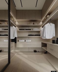 an empty walk in closet with clothes hanging on the shelves and shoes sitting on the floor