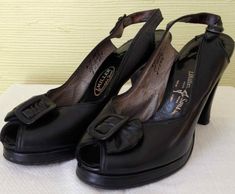 "Made by L Miller and Sons in New York. Black leather with half bow detail on each shoe, with sling back straps. Shoes and are in excellent condition. Heel to toe- 9\" or US 6 1/2 Vintage garments have been previously worn and lovingly cared for, they may however have a blemish or two. Here at MadelonVintage, I try my very best to note all the details of each garment, although I may sometimes overlook things, which I do apologise for. Please do not expect perfection, unless stated so. Please mak Vintage Formal Sandals With 4-inch Heel, Vintage Leather Heels With Bow, Vintage Open Toe Slingback Pumps, Vintage Evening Sandals With Heel Strap, Retro Formal Sandals With Pointed Toe, Vintage Heels With Heel Strap For Formal Occasions, Vintage Formal Heels With Heel Strap, Formal Retro Pointed Toe Sandals, Vintage Slingback Pumps For Formal Occasions