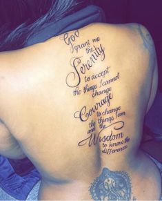 the back of a woman's lower back tattoo with words written in cursive writing