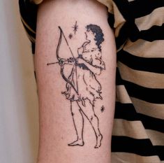 a woman with a bow and arrow tattoo on her arm