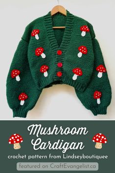 a green knitted sweater with mushrooms on the front and red dots on the back