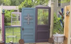 a blue and purple door in the middle of a yard