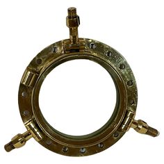 an old brass porthole with screws and nuts