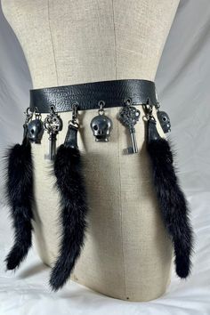 "You are looking at a genuine  black belt by Ronald Pine.  Belt measures 38\"6 long, 1\"4 wide, measuring 31\"5 in the first perforation and 35\"4 at the last perforation from buckle. Belt comes with aged dark silver tone hardware, skulls and keys along with lovely fur. This lovely belt has great craftsmanship with three lovely detachable fur tags. The leather is thick and strong and belt was well cared for. Made in France.  -----------------------------------------I SHIP WORLDWIDE-------------- Fur Belt, Skull Belt, Fur Accessories, Leather Lace Up Boots, Beautiful Boots, Black Leather Belt, Buckle Belt, Black Belt, Lace Up Boots