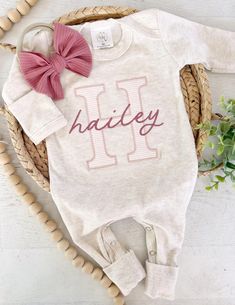 This sweet personalized baby sleeper is soft and comfortable to snuggle a little one. This custom outfit makes a perfect coming home outfit, newborn pictures, or baby shower gift. This features a soft oatmeal romper, a large initial in a pink stripe with name in a deep pink color across the front.  Preemie 5-7lbs Newborn fits approximately 6-9lbs 0/3 fits approximately 9-14lbs 3/6 fits approximately 13-17lbs 6/12 fits approximately 15-21lbs Please leave name in the notes to seller box at checkou Customizable Cute Pink Onesie, Pink Cotton Onesie As A Gift, Pink Cotton Onesie For Gift, Pink Cotton Onesie As Gift, Fitted Pink Onesie For Gift, Fitted Pink Onesie As A Gift, Fitted Pink Onesie Gift, Pink Fitted Onesie As A Gift, Cute Pink Onesie With Name Print