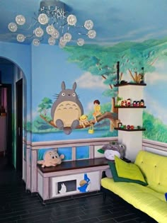 a living room with a couch, table and cartoon wallpaper on the walls in it