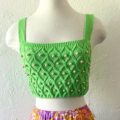 a mannequin wearing a green crop top and colorful skirt