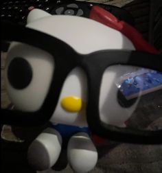 a close up of a stuffed animal wearing glasses