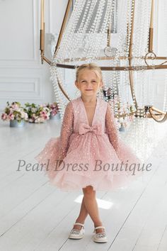 "Transform your little one into a vision of charm and grace with our Pink Flower Girl Dress. This enchanting ensemble is not just a dress; it's a dream come true for your baby's special moments, whether it's a birthday celebration, a fairy-themed party, or a cherished role as a flower girl. Crafted with meticulous care and attention to detail, this baby tulle dress combines the innocence of a baby party dress with the elegance of a flower girl dress. The soft, airy tulle skirt billows gently, creating a fairy-tale silhouette that will make your toddler look and feel like royalty. This Tutu Dress is more than just a birthday dress; it's a timeless piece that can be cherished for years to come. The delicate pink hue adds a touch of playfulness and enchantment, making it the perfect choice fo Whimsical Pink Tutu Dress For Birthday, Playful Pink Dress For First Birthday, Pink Ruffled Dress For First Birthday, Pink Playful Princess Dress For First Birthday, Pink Floral Applique Tutu Dress For Birthday, Baby Tulle Dress, Fairy Princess Costume, Toddler Party Dress, Girls Ball Gown