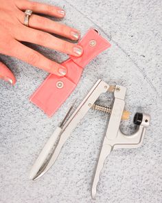 a woman's hand with manicures and tools on the ground next to her