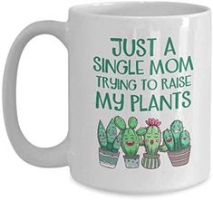 a white coffee mug that says, just a single mom trying to raise my plants