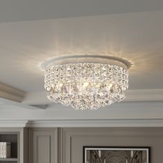 a crystal chandelier hanging from the ceiling in a room with gray walls and white trim