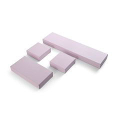 three pieces of pink foam sitting next to each other on top of a white surface