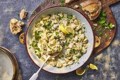 a bowl of pasta with lemons and parsley