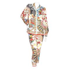 Product Details: Silk print pant suit by Dolce & Gabbana Multicolor print Fan print with Sicilian figures Blouse: Pointed collar Long sleeve Button closure cuffs Button front closure Fluid silhouette Pant: Mid rise Flat front Fitted legs Zip side with hook and eye closure Made in Itay Condition: Good, some loose strings. Pulls in fabric throughout. Sold as is. (see photos) Size/Measurements: Size 42IT 38" bust 39" waist 25.5" length Pant: 27" waist 30" hip 34" pant length Patterned Long Sleeve Floral Print Set, Patterned Floral Print Long Sleeve Set, Long Sleeve Patterned Set With Floral Print, Long Sleeve Floral Print Patterned Set, Multicolor Long Sleeve Sets For Workwear, Multicolor Pant Set For Workwear, Multicolor Long Sleeve Sets For Work, Designer Long Sleeve Sets For Spring, Patterned Long Sleeve Printed Sets