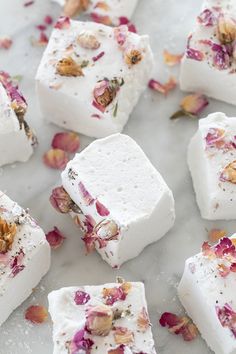 several pieces of white soap with dried flowers on them