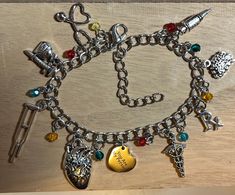 the charm bracelet has many charms on it