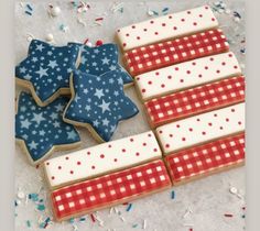 patriotic cookies are arranged on a table with confetti