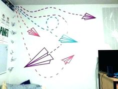 the wall is decorated with colorful paper airplanes