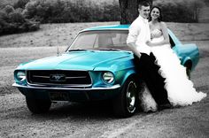 a bride and groom standing next to a turquoise mustang