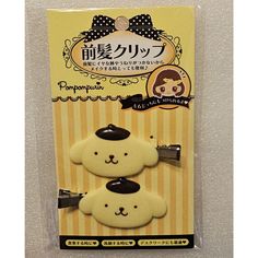 two white and black teddy bears in front of a yellow package with japanese writing on it