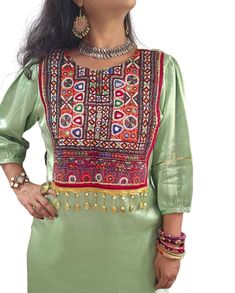 Step into elegance and sustainability with our exquisite green pista Kutchi kurta, meticulously handcrafted from Kutchi mashroo cotton silk--a fabric known for its luxurious texture and eco-friendly properties. This kurta isn't just a garment; it's a masterpiece of artisanal skill from the artisans of Kutch, who have embellished its front with intricate embroidery. Each stitch not only enhances its beauty but also empowers the local craftsmen, providing them with sustainable livelihoods and show Pista Green Colour, Afghani Dress, Pista Green, Work Jacket, Intricate Embroidery, Work Jackets, Mirror Work, Working Woman, Green Colour