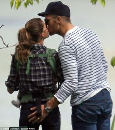 a young man and woman kissing each other