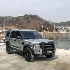 an suv is parked near the water