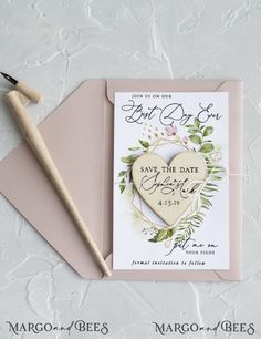 a wedding card with a heart on it next to a pen