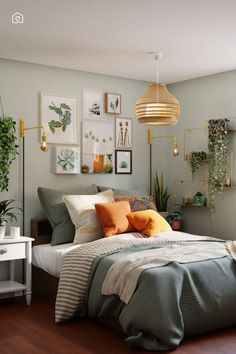 a bed sitting in a bedroom next to a lamp and pictures on the wall above it