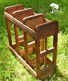 two wooden chairs sitting in the grass