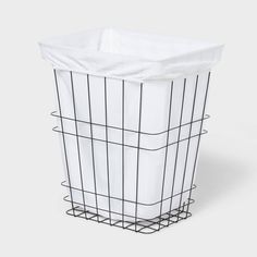 a white basket with black wire on top