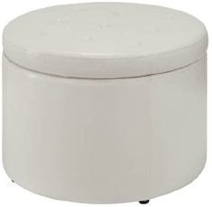 a white round ottoman sitting on top of a table