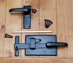 an assortment of hardware on a wooden floor with screws and nails in the middle