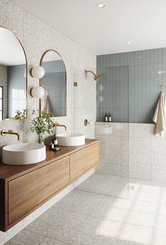 a bathroom with two sinks and mirrors on the wall next to a bathtub in front of a window