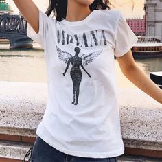 Vintage Styled Band Tee ‘Nirvana’ With Winged Angel. Soft Comfortable Material With A Little Stretch. 97% Cotton & 3% Spandex This Is *Not* Free People. Also Listed In Black And Pink Our Boutique Is Filled With A Curated Collection Of Styles: Spell Gypsy Boho Bohemian Hippie Retro Vintage Handmade Coachella Festival Free People Anthropologie Johnny Was Urban Outfitters Western Aztec Tribal Floral Vacation Fall Winter Spring Summer Casual Mumu Cocktail Love Lemons Coat Nirvana White T Shirt, Summer Concert Crew Neck Top, Summer Concert Crew Neck T-shirt, Summer Concert Crew Neck Shirt, Summer Crew Neck Shirt For Concert, White Relaxed Fit Top For Music Festival, White Grunge Shirt For Summer, White Summer Grunge Shirt, White Tops For Concerts In Spring