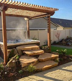 an outdoor hot tub in the middle of a yard with steps leading up to it